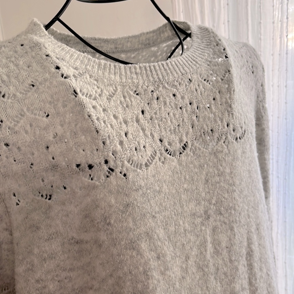 Soft pale gray sweater with detail at neck & arms. Size m. Used condition.